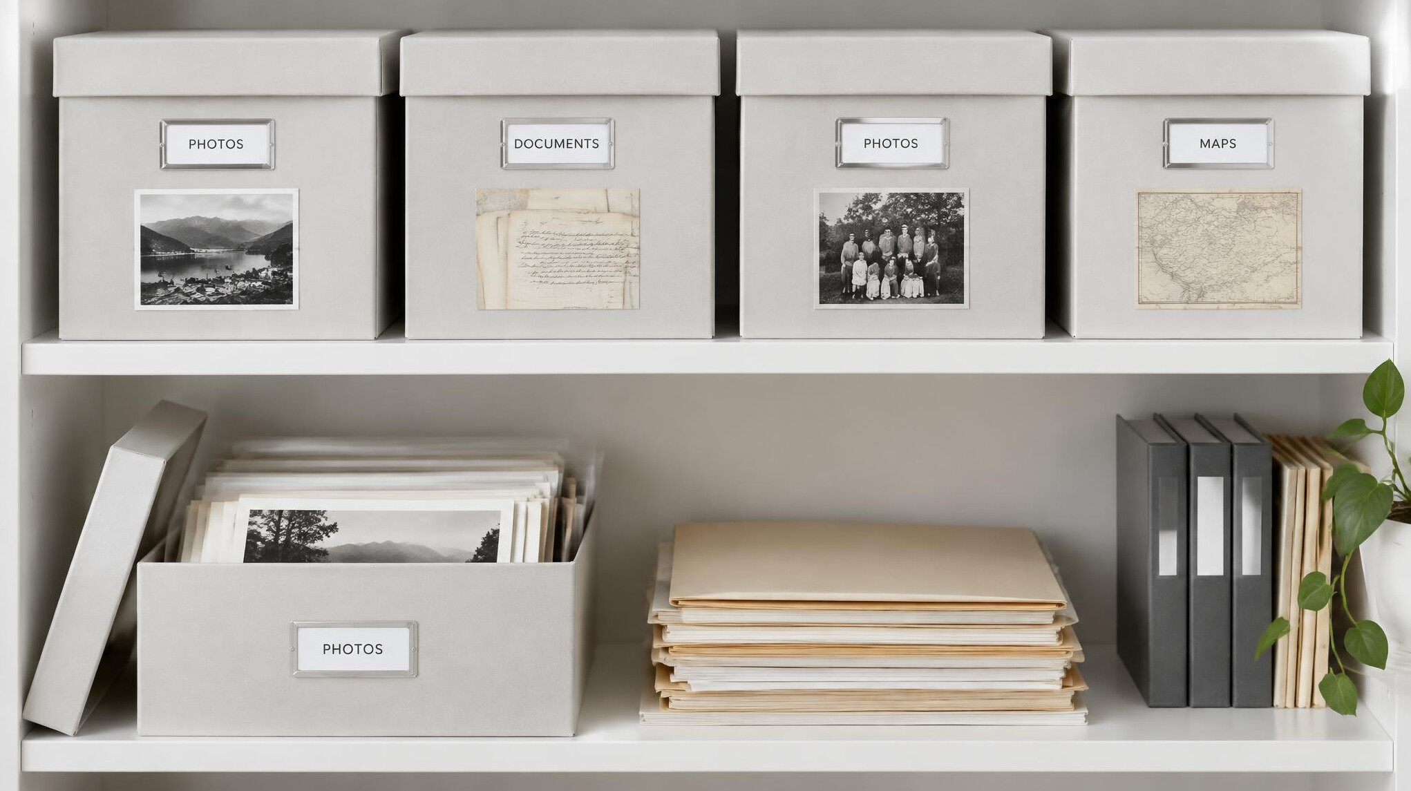 Labelled storage boxes with archived photos on a shelf